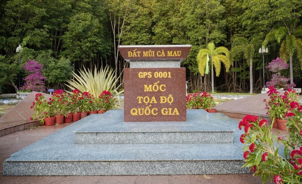 Tourists posing at the GPS 0001 landmark at Cape Ca Mau