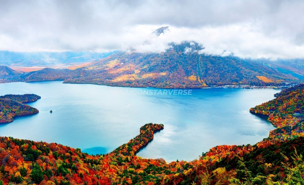 Lake Chuzenji reflecting mountains covered in autumn leaves, creating a magical scene.