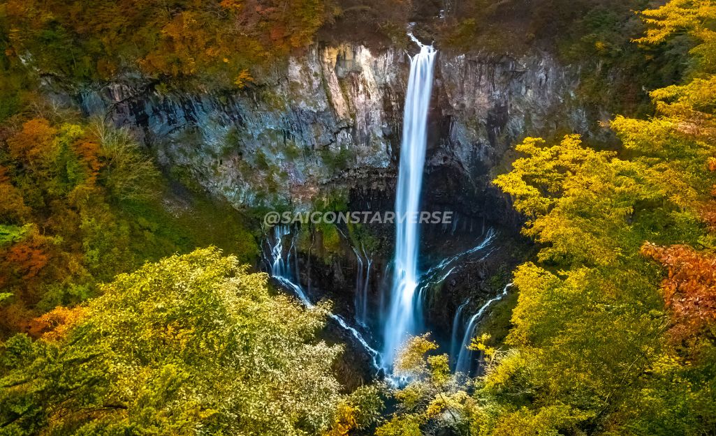 Kegon Falls framed by vibrant autumn colors, showcasing the contrast of Nikko's fall nature